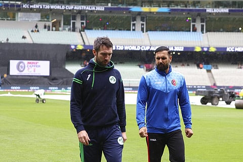 Ireland's captain Andrew Balbirnie, left, and Afghanistan's captain, Mohammad Nabi walk from the field after their match was abandoned due to rain at the T20 World Cup cricket in Melbourne | AP