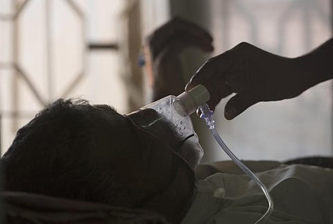 A relative adjusts the oxygen mask of a tuberculosis patient at a TB hospital on World Tuberculosis Day in Hyderabad, India, March 24, 2018. (File Photo | AP)