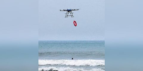 A drone drops a lifebuoy to a man in the sea during a rescue demonstration at Marina Beach in Chennai on Saturday | P Jawahar