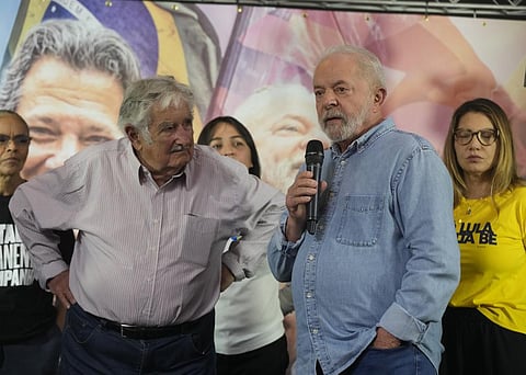 Uruguay's former President Jose Mujica, left, listens to Luiz Inacio Lula da Silva, who is running for the presidency again, during a campaign event in Sao Paulo, Brazil, Oct. 29, 2022. (Photo | AP)