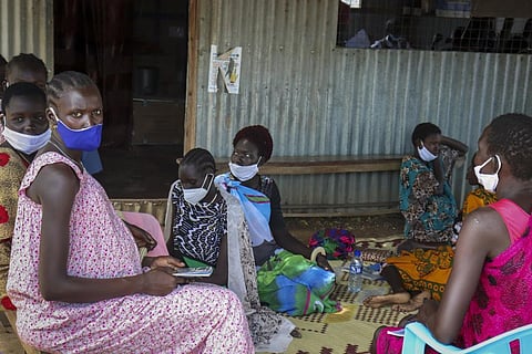 Expectant mothers sit on the floor as they wait to attend a monthly checkup at the Mingkaman Reproductive Health Clinic on Wednesday, Oct. 19, 2022. (Photo | AP)