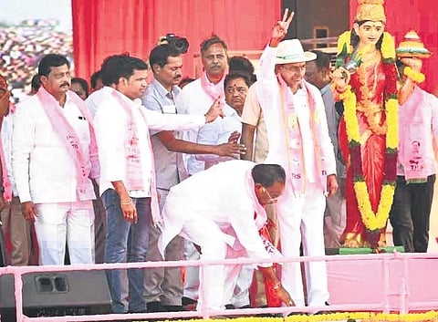 TRS’ Munugode bypoll candidate K Prabhakar Reddy seeks blessings of Chief Minister K Chandrasekhar Rao while the latter greets the crowd gathered for the public meeting at Bangarigadda in Chandur on S