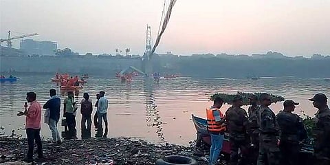 Rescue operation underway after an old suspension bridge over the Machchhu river collapsed, in Morbi district, Sunday, Oct. 30, 2022. (PTI)