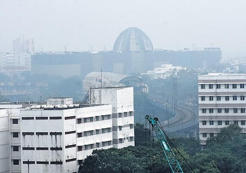 (Top) Fog engulfed Chennai following rain on Wednesday; a woman selling mangoes near Chennai Central, braving the showers | Ashwin Prasath