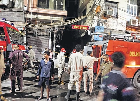 Fire fighters douse a fire broke which out at the cloth market at Gandhi Nagar, in New Delhi, Wednesday, Oct 5, 2022. (PTI Photo)