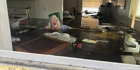 In this photo provided by Johnny Lauder, Lauder's mother, Karen Lauder, 86, is submerged nearly to her shoulders in water that has flooded her home, in Naples. (Photo | AP)