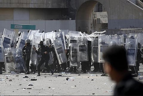 Iraqi security forces clash with supporters of Shiite Muslim cleric Moqtada Sadr in Tahrir Square in the centre of Iraq s capital Baghdad. (Photo | AFP)