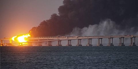 Flame and smoke rise fron Crimean Bridge connecting Russian mainland and Crimean peninsula over the Kerch Strait, in Kerch, Crimea. (Photo | AP)