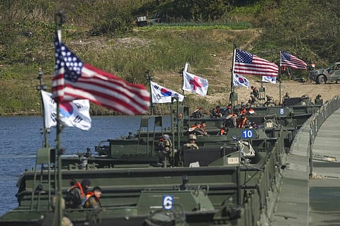 Flags of South Korea and the United States flutter before a joint river-crossing drill between South Korea and the United States in Yeoju, South Korea on Oct. 19, 2022.  (Photo | AP)