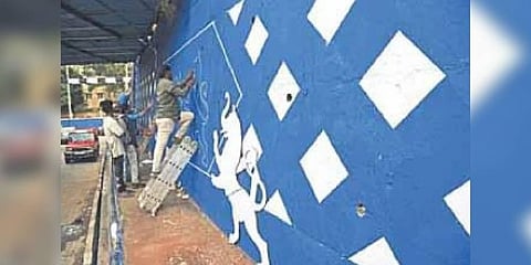 A wall being painted ahead of the Global Investors’ Meet 2022 on Palace Road in Bengaluru on Monday | Vinod kumar T