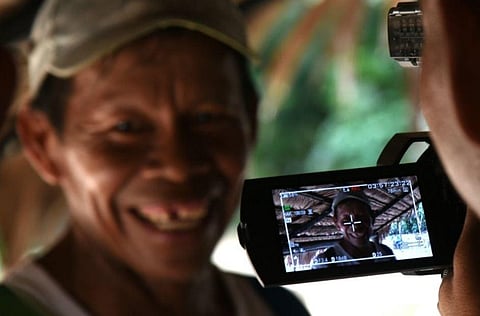 A Tikuna indigenous woman poses for the camera during the filming of a documentary short film in the community of San Martin de Amacayacu in Colombia | AFP