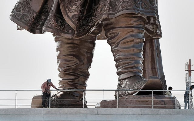 Workers near the 108 feet statue of Nadaprabhu Kempegowda at Kempegowda International Airport in Bengaluru. (Photo | PTI)