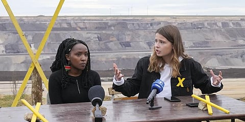 Activists Luisa Neubauer, from Germany, right, and Elizabeth Wathuti, from Kenya, talk to the media  at the Garzweiler open-cast coal mine near Luetzerath, western Germany.(File Photo | AP)
