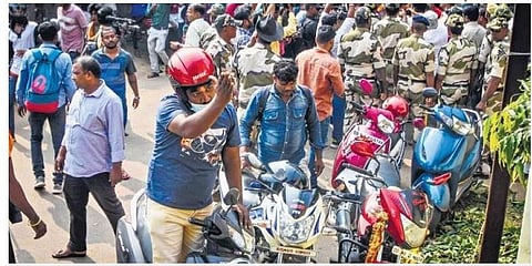 A member of Bajrang Dal gestures at rationalists who were distributing chicken biryani on lunar eclipse at Lohia Academy in Bhubaneswar on Tuesday | Express