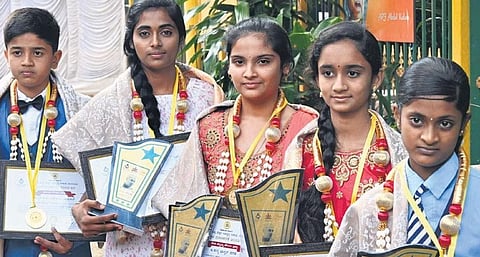 (From left) Keerthi Vivek, Namrata, Kavya Bhaskar Hegde, Koushalya Hegade and Prarthana with the bravery awards they received at a Children’s Day programme at Bal Bhavan on Monday | SHASHIDHAR BYRAPPA