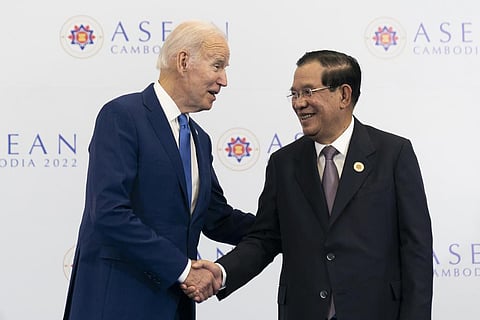 U.S. President Joe Biden shakes hands with Cambodian Prime Minister Hun Sen before their meeting during the ASEAN summit. (Photo | AP)