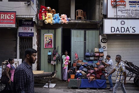Street hawkers open up their business for the day at a market place in Colombo, Sri Lanka, Monday, Nov. 14, 2022. (Photo | AP)