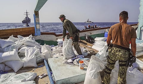Sailors inventory urea and ammonium perchlorate found on a dhow intercepted in the Gulf of Oman (Photo | AP)