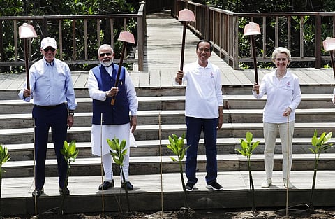 U.S. President Joe Biden, Indian PM Narendra Modi, Indonesian President Joko Widodo, European Commission President Ursula von der Leyen hold up shovels as they pose for photos. (Photo | AP)