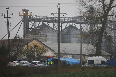 Police officers work outside a grain depot where, according to the Polish government, an explosion of a Russian-made missile killed two people in Przewodow, Poland. (Photo | AP)