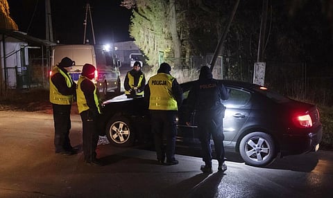Police officers gather outside a grain depot in Przewodow, Poland, on November 15, 2022 where the Polish Foreign Ministry said that a Russian-made missile fell and killed two people. (Photo | AP)