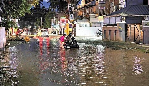 Motorists struggle on the waterlogged and potholed Kallattumukku-Kamaleswaram road on Tuesday | B P Deepu