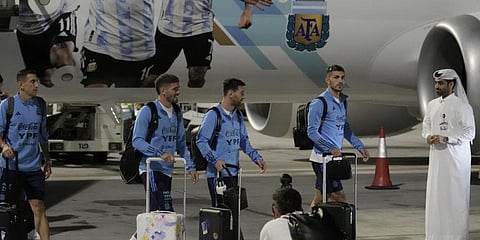Angel Di Maria, left, and Lionel Messi, second right, of Argentina's national soccer team arrive with teammates at Hamad International Airport in Doha.(Photo | AP)