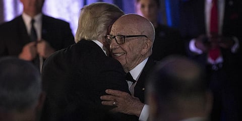 Former U.S. President Donald Trump embraces Australian-American media proprietor Rupert Murdoch. (File Photo | AFP)