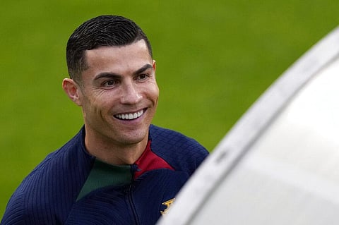 Cristiano Ronaldo smiles as he arrives for a Portugal soccer team training session in Oeiras, outside Lisbon, Monday, Nov. 14, 2022. (Photo | AP)