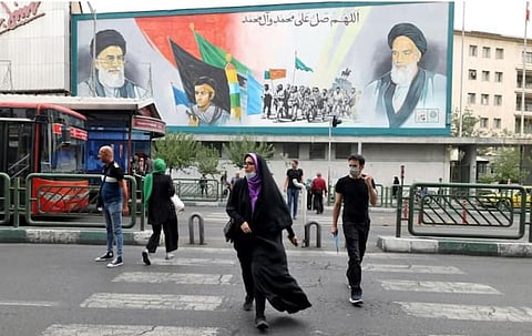 A billboard showing Iran's supreme leader Ayatollah Ali Khamenei and Ayatollah Ruhollah Khomeini (R) in Tehran, before the anti-regime protest movement began in September 2022. (Photo | AFP)