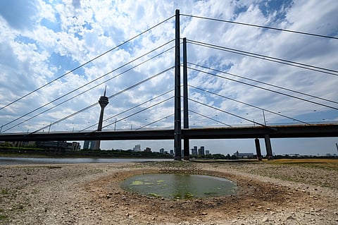 Dry soil of the partially dried-up river bed of the Rhine in Duesseldorf, Germany, July 25, 2022, as Europe experiences a heatwave. (File Photo | AFP)