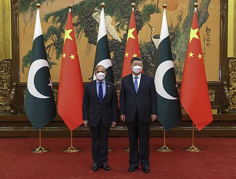 Chinese President Xi Jinping, (R), poses with Pakistani Prime Minister Shahbaz Sharif before their bilateral meeting at the Great Hall of the People in Beijing, Nov. 2, 2022. (Photo | AP)