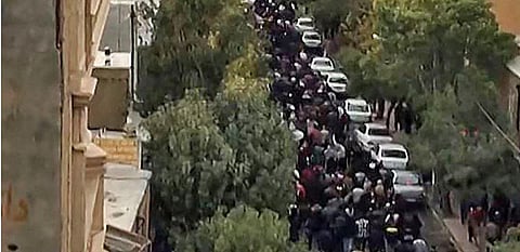 This image grab from a UGC video shows protesters marching on a street in Iran's Kurdish city of Mahabad. (Photo | AFP)