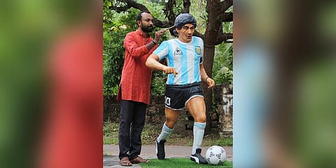 Chithran Kunhimangalam near the sculpture of Maradona.