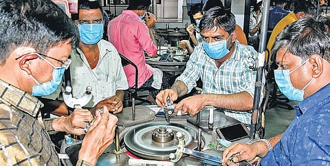Representational image of Diamond workers wearing masks go about with their work at a jewellery shop in Surat. (Photo | PTI)