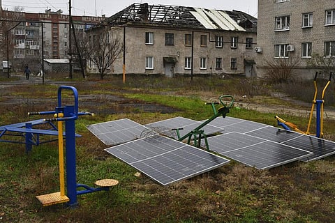 Solar panels seen in the yard of an apartment building in Lyman, Donetsk region, Ukraine, Sunday, Nov. 20, 2022. (Photo | AP)
