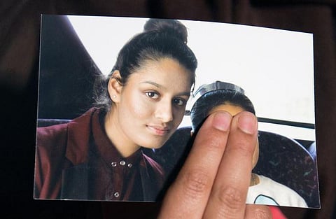 Renu, eldest sister of missing British girl Shamima Begum, holds a picture of her sister while being interviewed by the media in central London. (Photo | AFP)