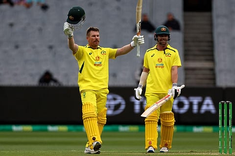 Australia's David Warner, left, is watched by teammate Travis Head, as he celebrates making 100 runs against England during their one-day international cricket match. (Photo | AP)