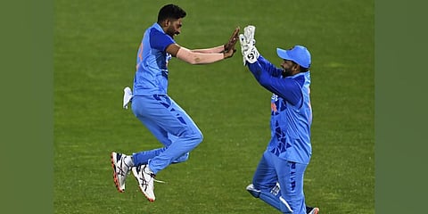 India's Mohammed Siraj, left, celebrates the wicket of New Zealand's Mitchell Santner during their T20 cricket international in Napier, New Zealand. (Photo | AP)