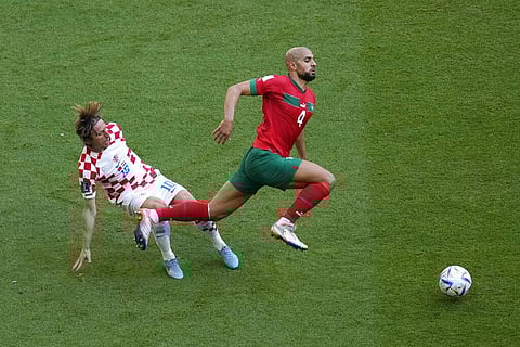 Croatia's Luka Modric, (L), and Morocco's Sofyan Amrabat vie for the ball during the World Cup group F match between Morocco and Croatia at the Al Bayt Stadium, Nov. 23, 2022. (Photo | AP)