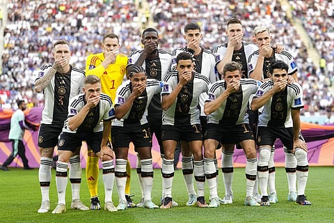 Players from Germany pose for the team photo as they cover their mouth before the World Cup group E match between against Japan, at the Khalifa International Stadium, Nov. 23, 2022. (Photo | AP)