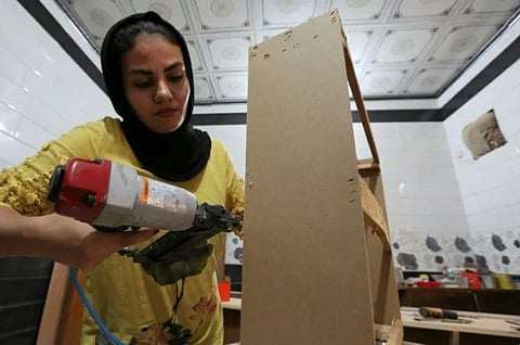 Iraqi carpenter Nour al-Janabi works at her home furniture workshop in Baghdad's Abu Dsheer area, on November 13, 2022. (Photo | AFP)