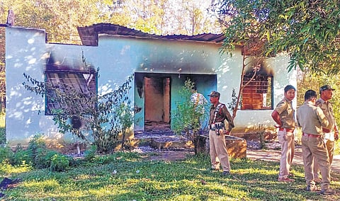 Security personnel stand guard near a forest office, a day after it was vandalised and burnt down by miscreants at Assam-Meghalaya border area | PTI
