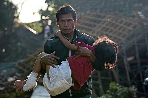 A man carries his injured daughter as they head to a temporary shelter for those displaced by Monday's earthquake in Cianjur, West Java, Indonesia, Thursday, Nov. 24, 2022. (Photo | AP)