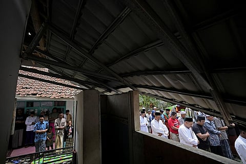 Muslim men perform a Friday prayer outside a mosque damaged in Monday's earthquake in Gasol village, Cianjur, West Java, Indonesia, Friday, Nov. 25, 2022. (Photo | AP)