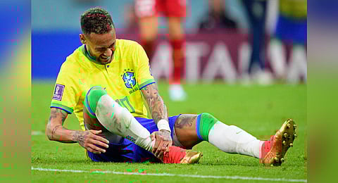 Brazil's Neymar grabs his ankle after an injury during the World Cup group G soccer match between Brazil and Serbia, at the the Lusail Stadium in Lusail, Qatar. (Photo | AP)