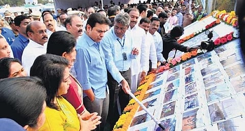 MAUD Minister KT Rama Rao briefed by officials during the inauguration of Shilpa Layout flyover in Hyderabad on Friday