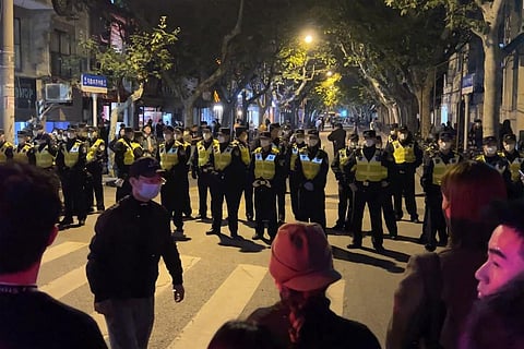 Chinese police officers block off access to a site where protesters had gathered in Shanghai on Sunday, Nov. 27, 2022. (Photo | AP)