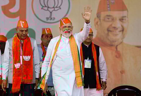 Prime Minister and senior BJP leader Narendra Modi waves at supporters at a public meeting ahead of the Gujarat Assembly elections, in Kheda district. (Photo | PTI)