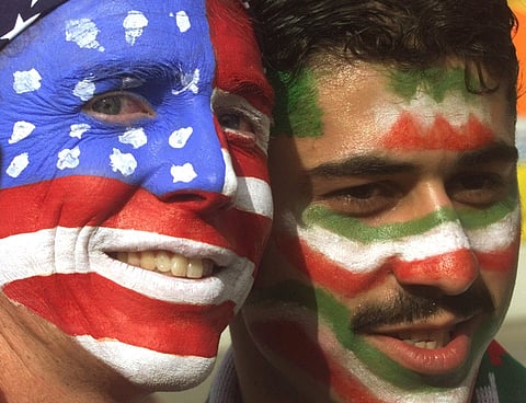 US supporter poses with an Iranian supporter living in Holland, on June 21, 1998, before the start of the USA vs Iran World Cup soccer match. (Photo | AP)